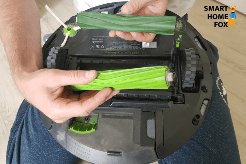 The two rubber brushes of an iRobot Roomba robot vacuum cleaner are removed.